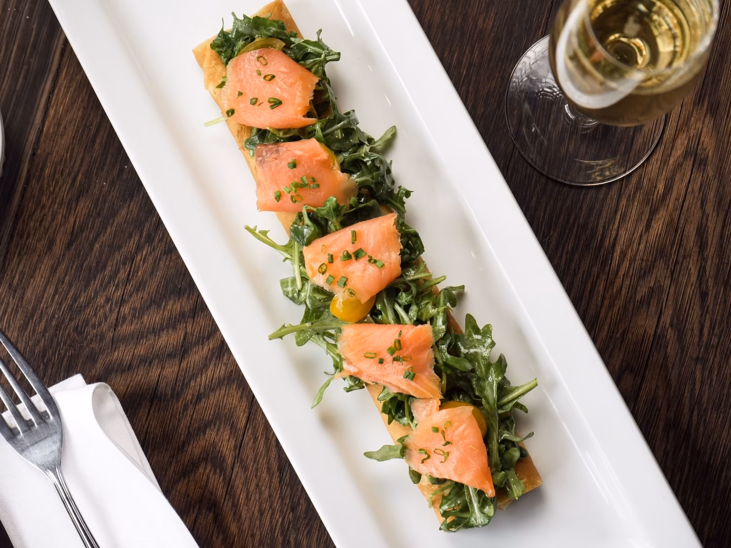 Smoked salmon, arugula, and cherry tomatoes over a long savory crêpe